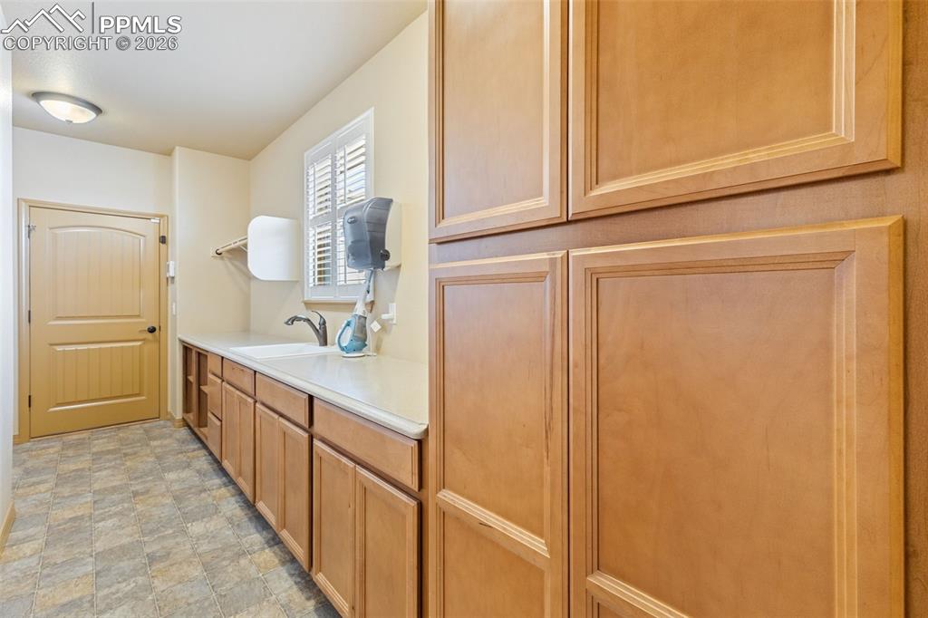 Laundry with sink and storage