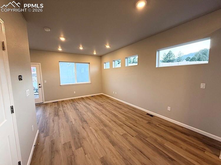 Living room with LVP flooring and walks out to back patio!