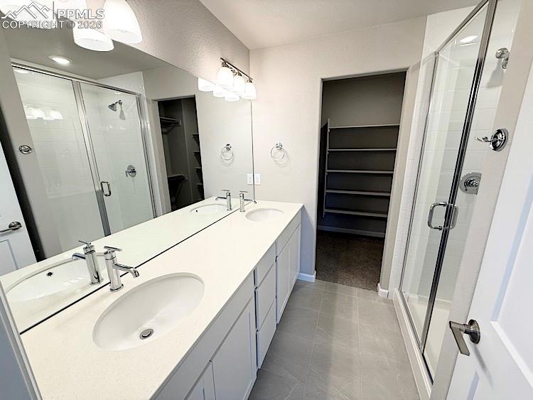 Primary Bathroom with Double Sinks, Large Shower, and Walk-in Closet