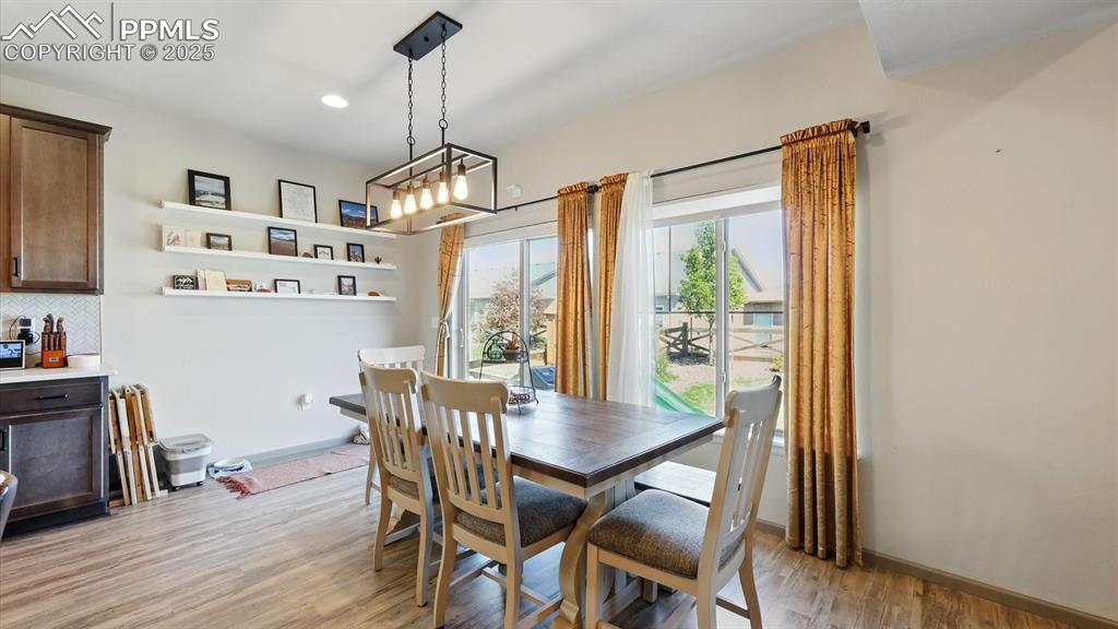 The Dining Room has an attractive modern light fixture and a sliding door out to the backyard patio.