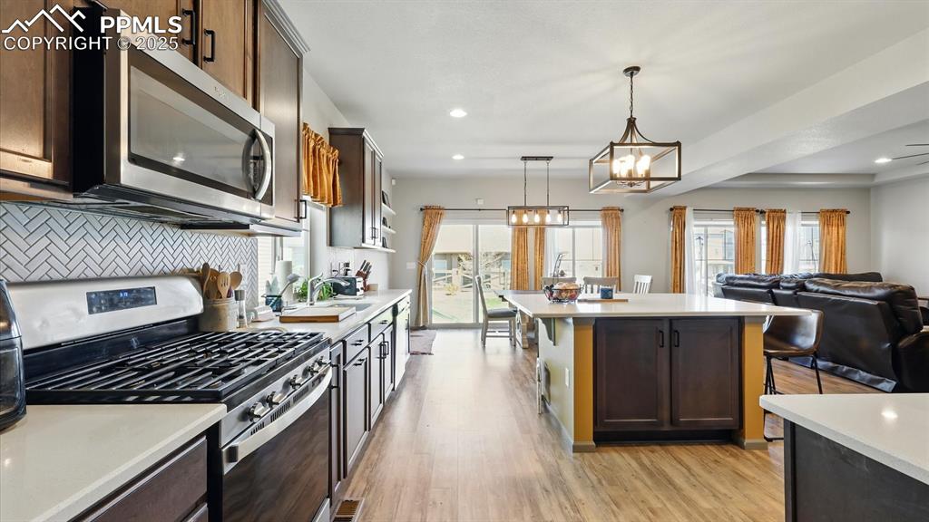 Appliances include a gas range oven, microwave, dishwasher, and French door refrigerator.