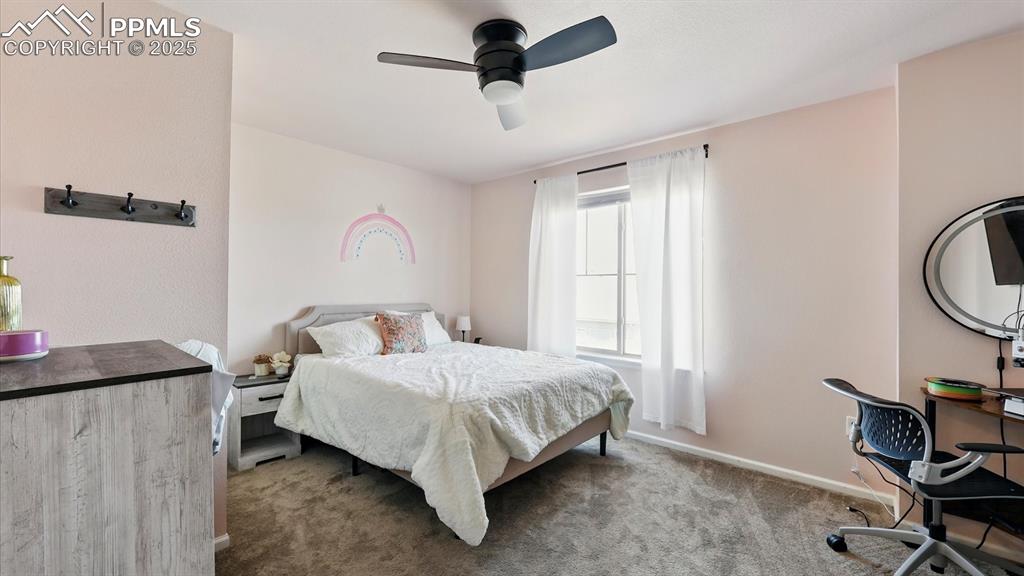 Upper Level Bedroom #2 with neutral carpet and a lighted ceiling fan.