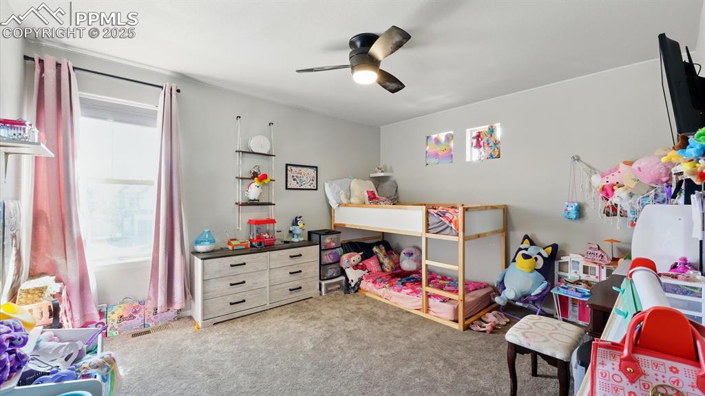 Upper Level Bedroom #3 has neutral carpet and a lighted ceiling fan.