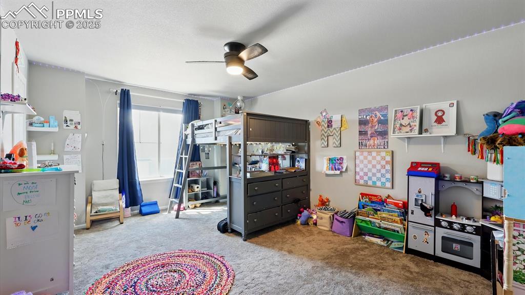 Upper Level Bedroom #4 has neutral carpet and a lighted ceiling fan.