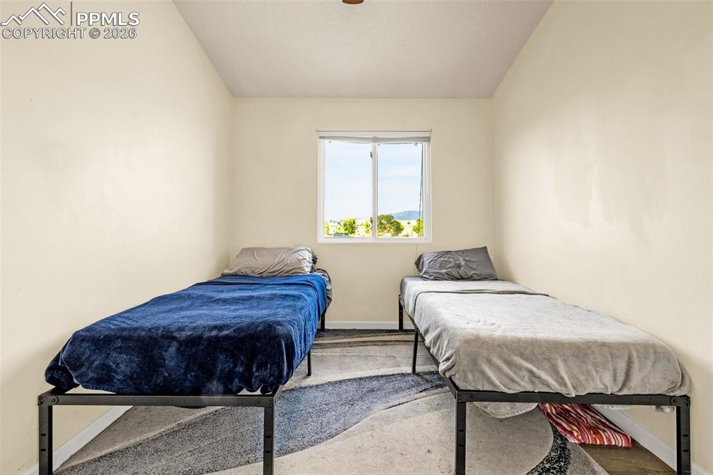 Bedroom featuring vaulted ceiling and ceiling fan