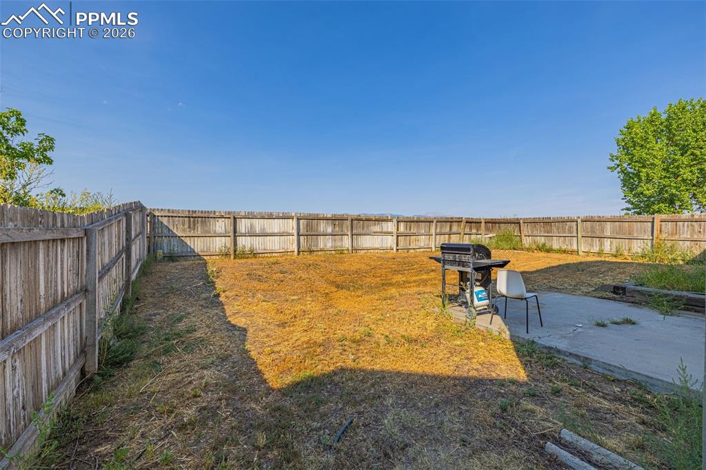 Fenced backyard featuring a patio area