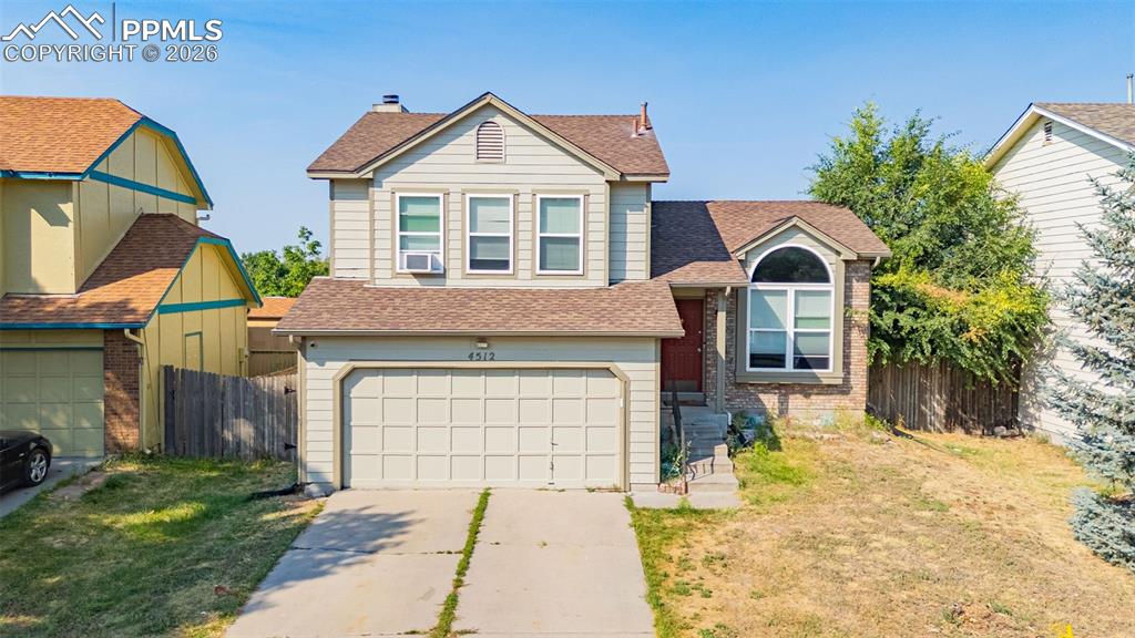 View of front facade featuring roof with shingles, a garage, and concrete driveway