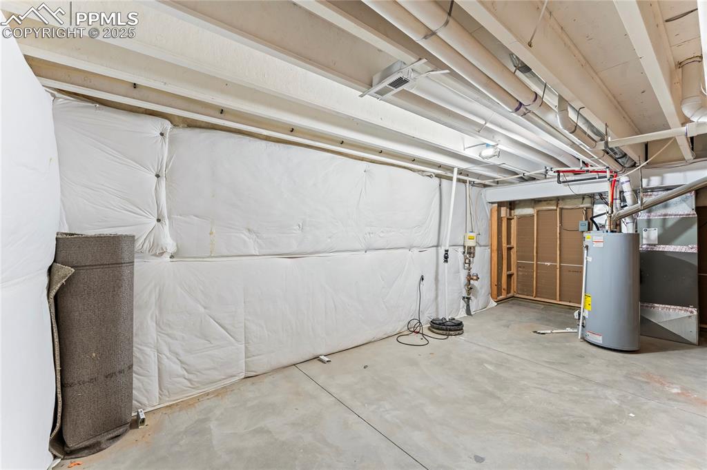 Unfinished below grade area with water heater and heating unit