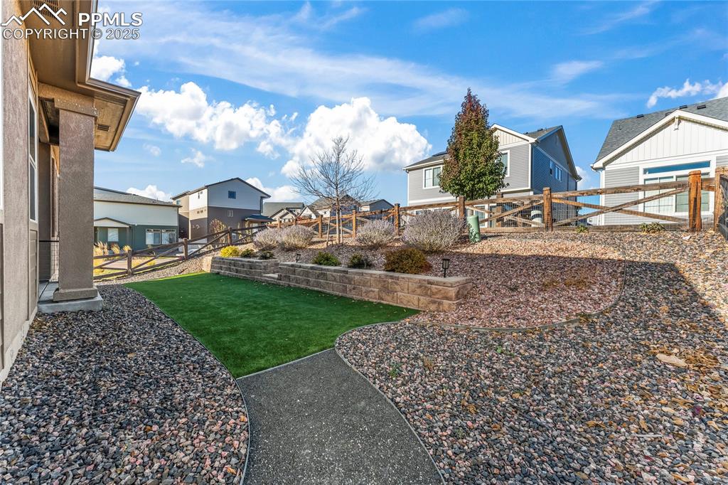 Fenced backyard with a residential view