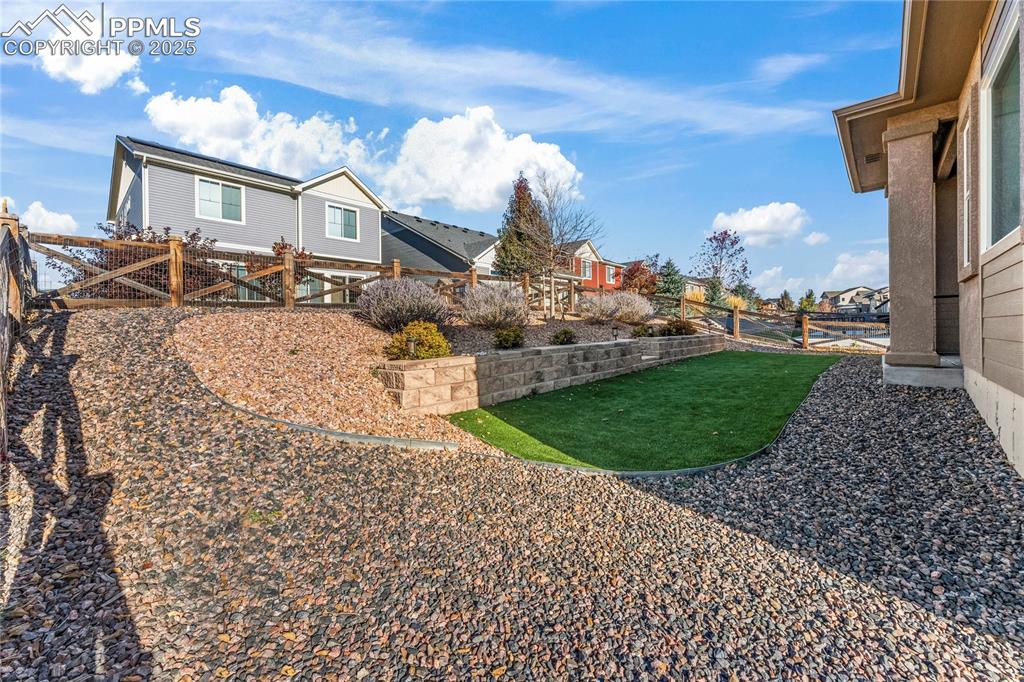 Fenced backyard with a residential view
