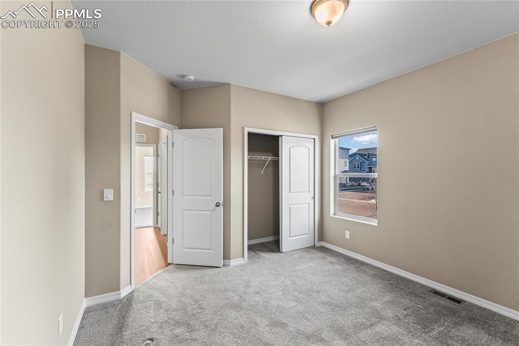 Unfurnished bedroom with carpet flooring and a closet