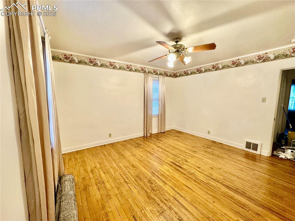 Unfurnished room featuring light wood-style flooring and a ceiling fan