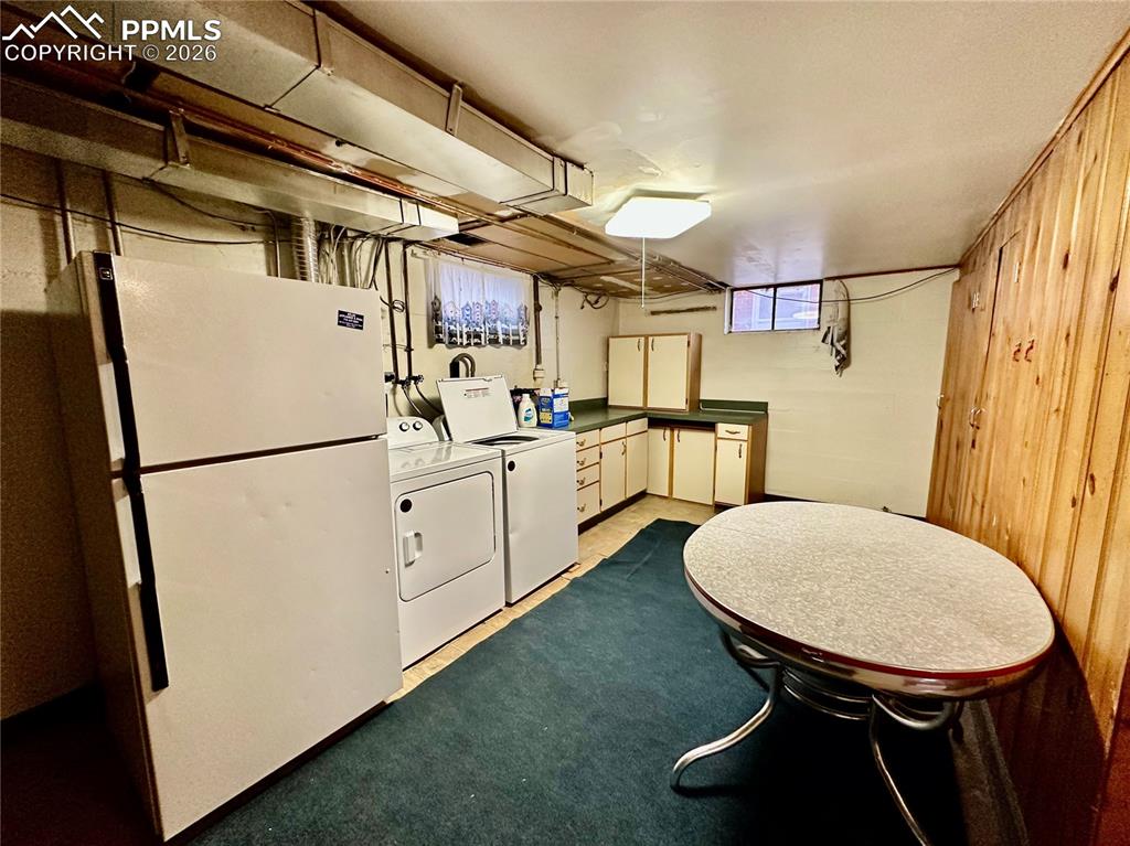 Laundry room with separate washer and dryer and cabinet space