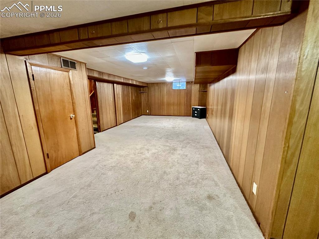 Finished below grade area with carpet floors and wood walls