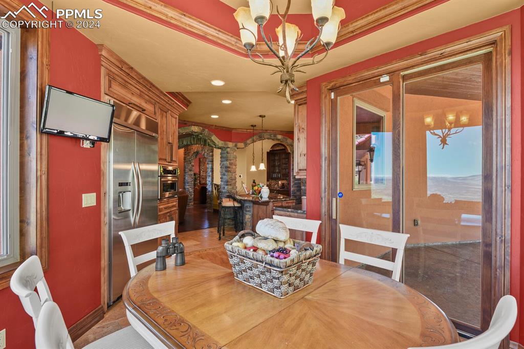 Tiled dining area with an inviting chandelier