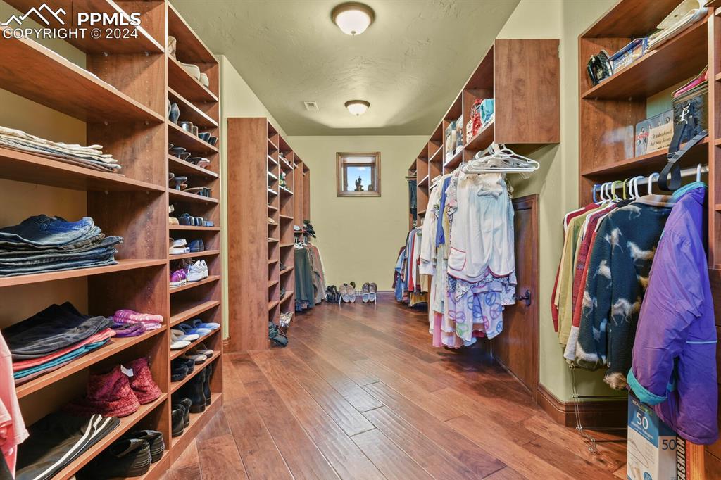 Spacious closet featuring hardwood / wood-style flooring