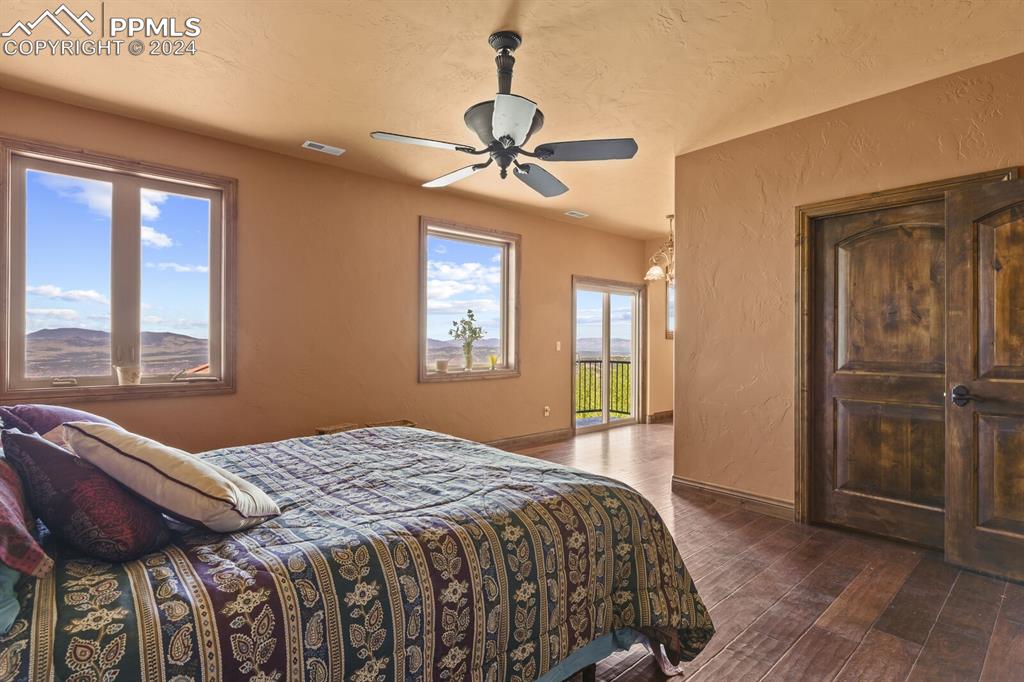 Bedroom with dark hardwood / wood-style flooring and ceiling fan