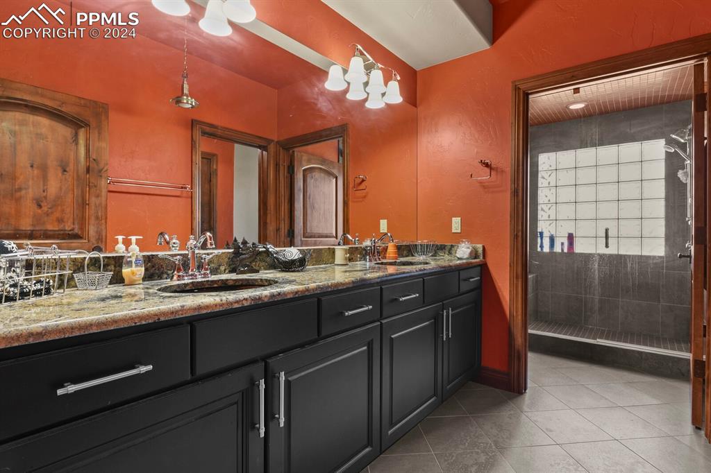Bathroom featuring tile flooring and double sink vanity