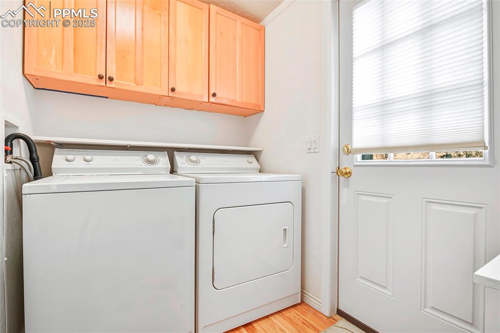 Laundry Room with Built-in Shelving and Cabinets for Extra Storage. Exterior Door to Private Back Yard Decking, Patio and Firepit