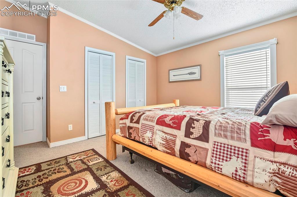 Master Bedroom off Kitchen with Double Closet Doors and Large Windows with Views of the Meadows