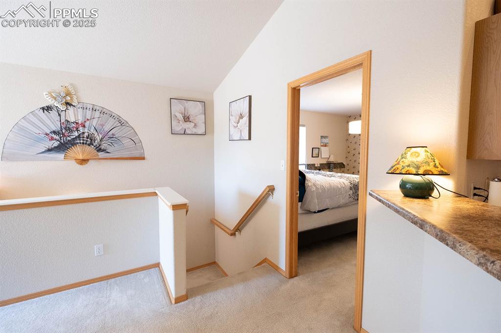 Off the family room is a bedroom and the steps leading to the lower level.