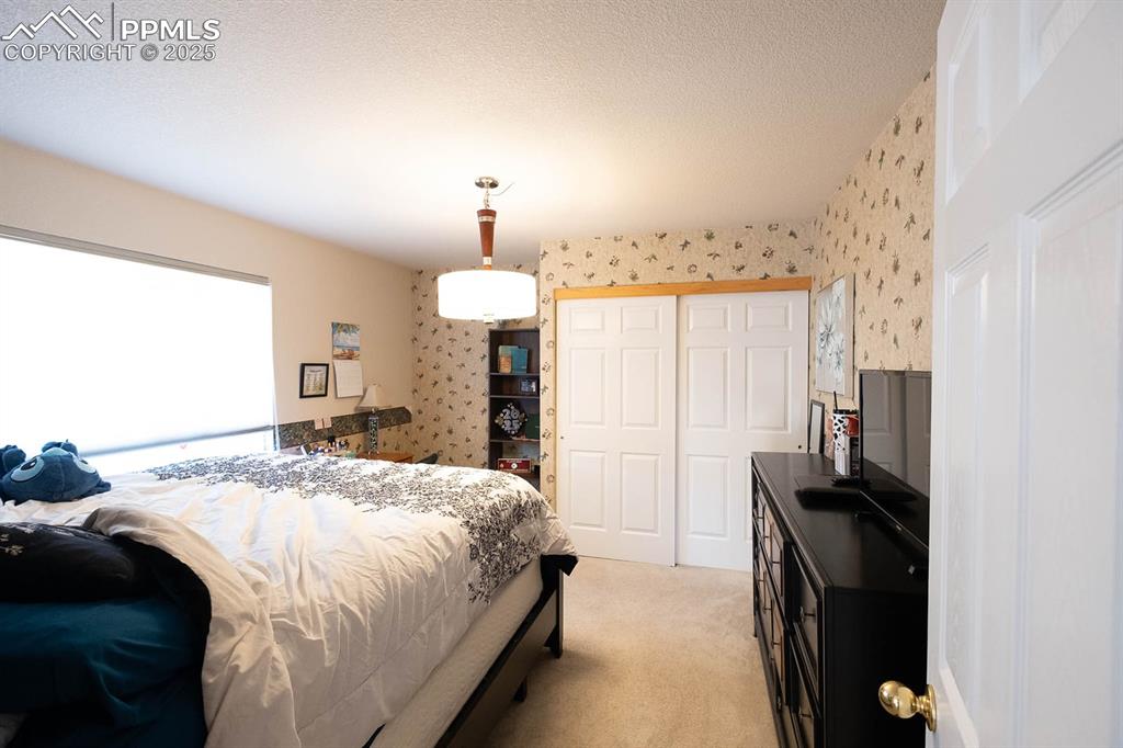 secondary bedroom at the back of the home off the staircase.
