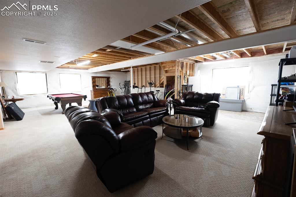 Needs some ceiling hung.  Area for kitchenette or wet bar.  It is carpeted.