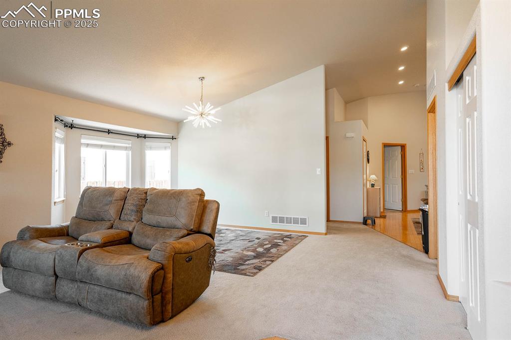 Living room, dining area towards the kitchen.