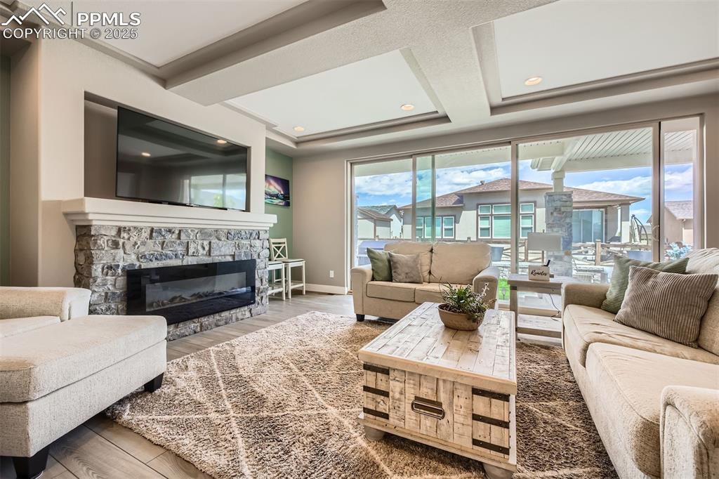 Oversized Colorado sliding glass doors open completely to enjoy the outdoor space seamlessly; electric fireplace is fully customizable