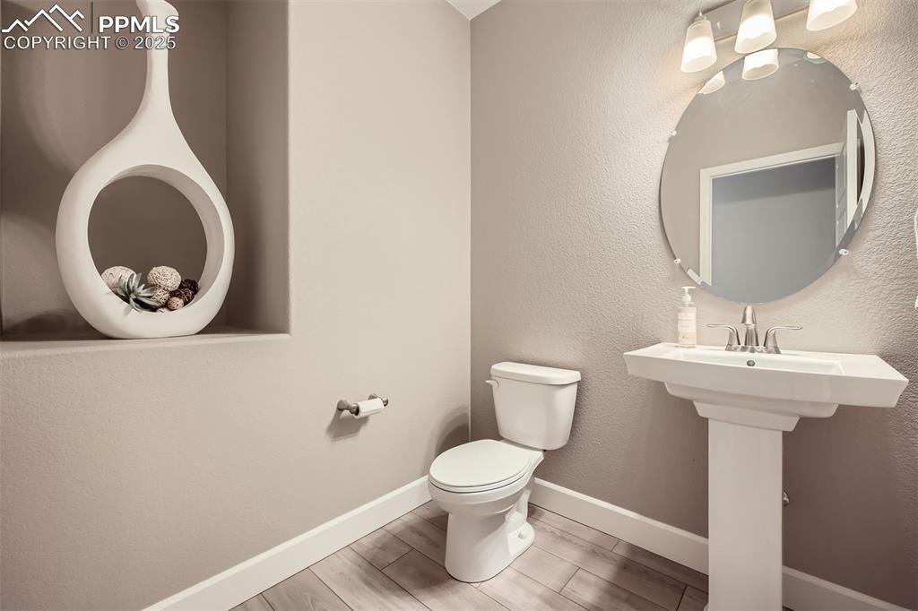 Even the half bath has custom built-in shelving - not shown are the mud room with coat hooks and seating plus the full size laundry with sink and storage.