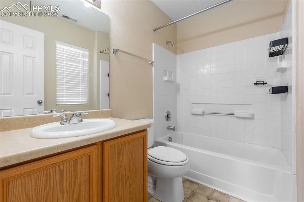 Primary Ensuite Bathroom featuring vanity,  shower combination, and tile patterned floors