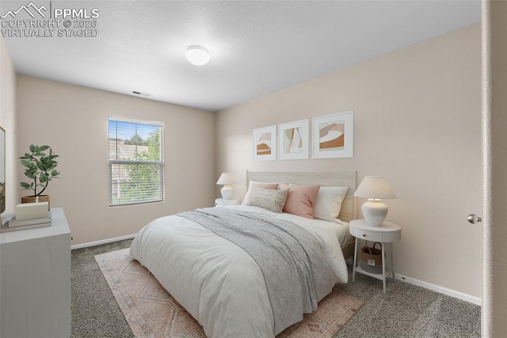 *Virtually Staged* Bedroom with light carpet and a textured ceiling