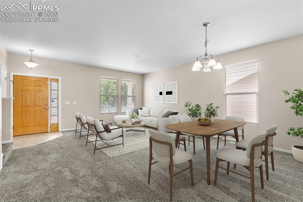 *Virtually Staged* Dining room featuring carpet and a chandelier