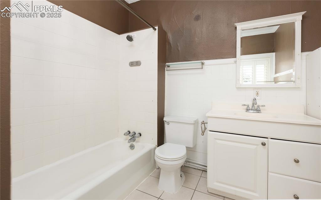 Full bathroom featuring light tile patterned floors, vanity, and shower / tub combination