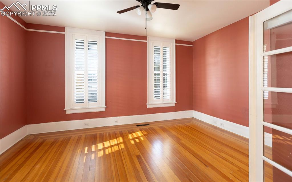 Empty room featuring light wood-style flooring and a ceiling fan