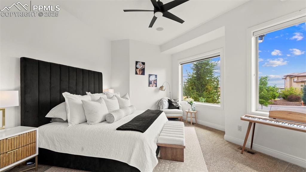 Bedroom featuring light carpet and ceiling fan