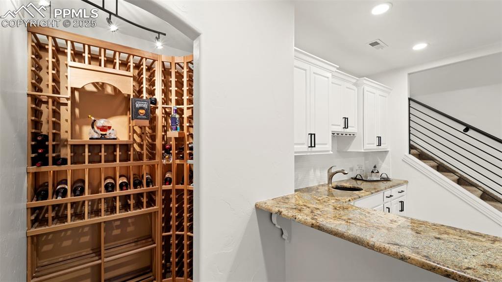 Wine cellar with a sink and recessed lighting