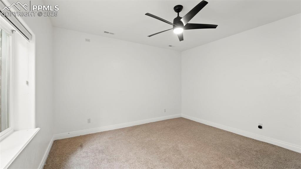 Spare room with carpet and ceiling fan