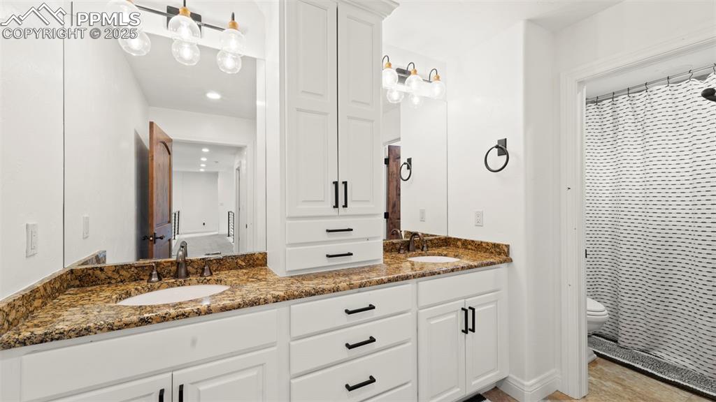 Bathroom with double vanity and a shower with shower curtain