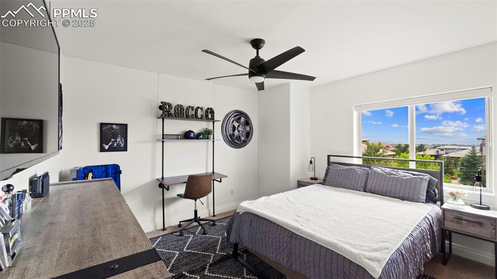 Bedroom with a ceiling fan and baseboards