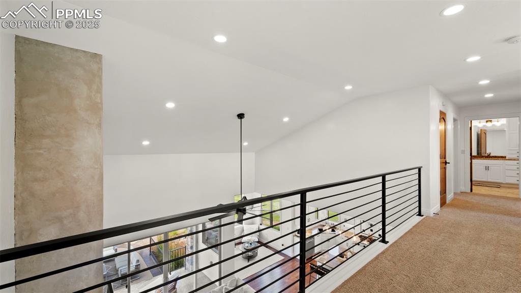 Corridor featuring recessed lighting, lofted ceiling, and light colored carpet