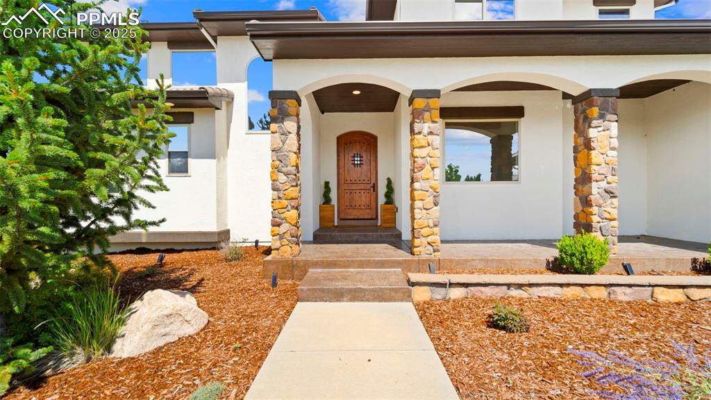 Entrance to property featuring stucco siding