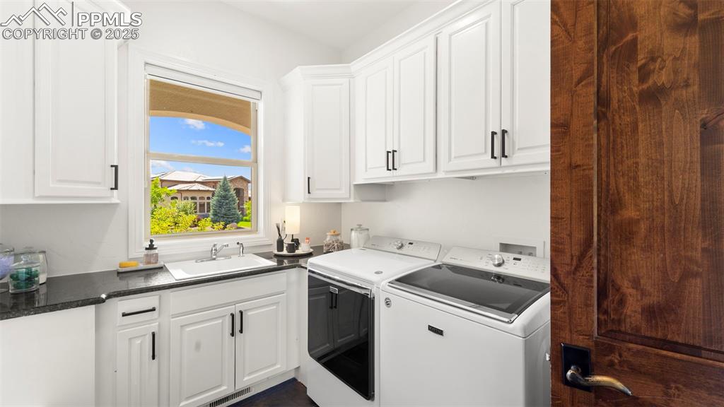 Laundry area with independent washer and dryer and cabinet space