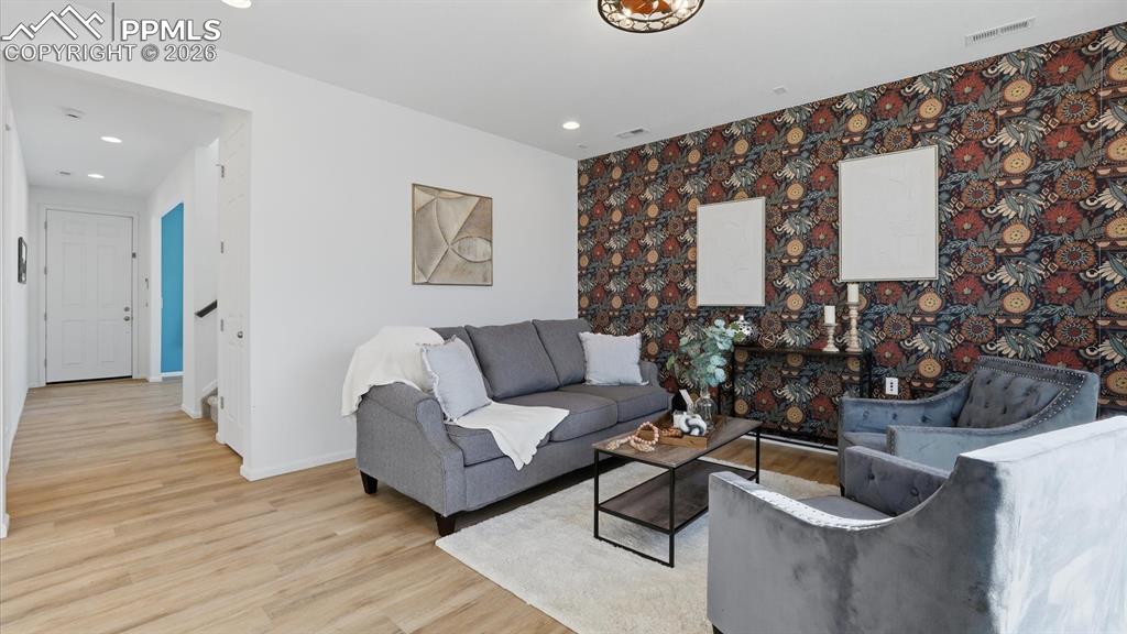 Great Room with ceiling fan and LVP flooring.