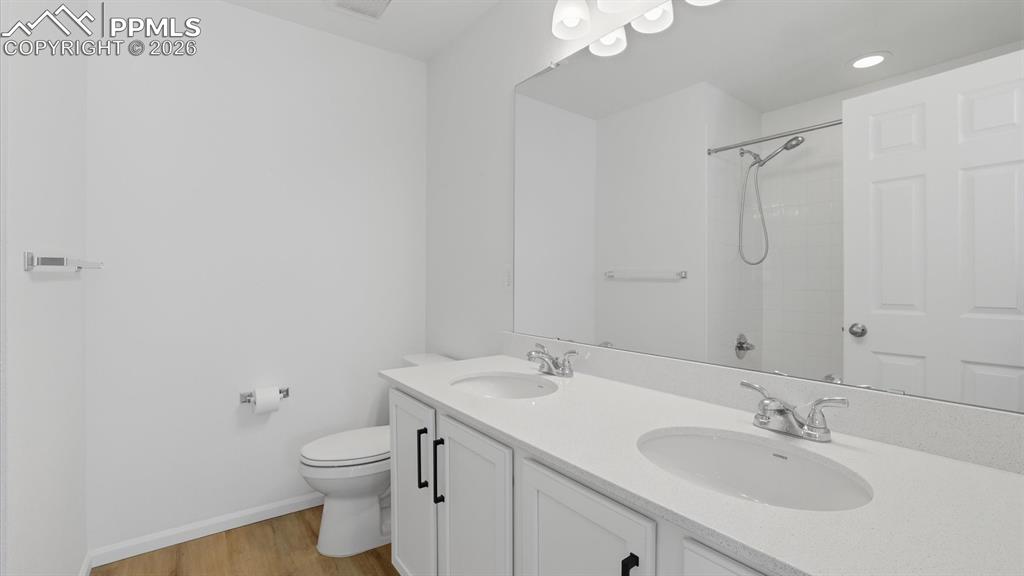 The upper level Full Bathroom features a dual sink vanity, mirror, and tiled tub/shower.
