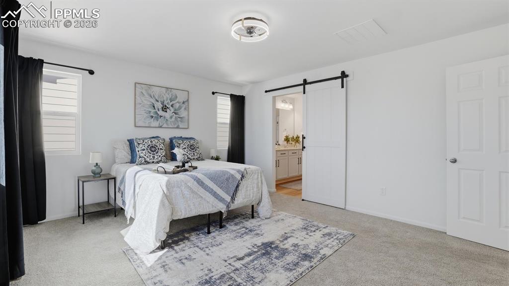 The upper level Primary Bedroom has a barn door into the spa-like Shower Bathroom.