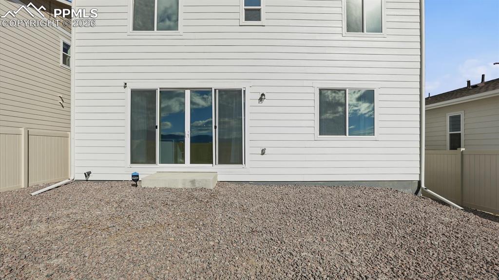 Rear view of backyard and back of structure.