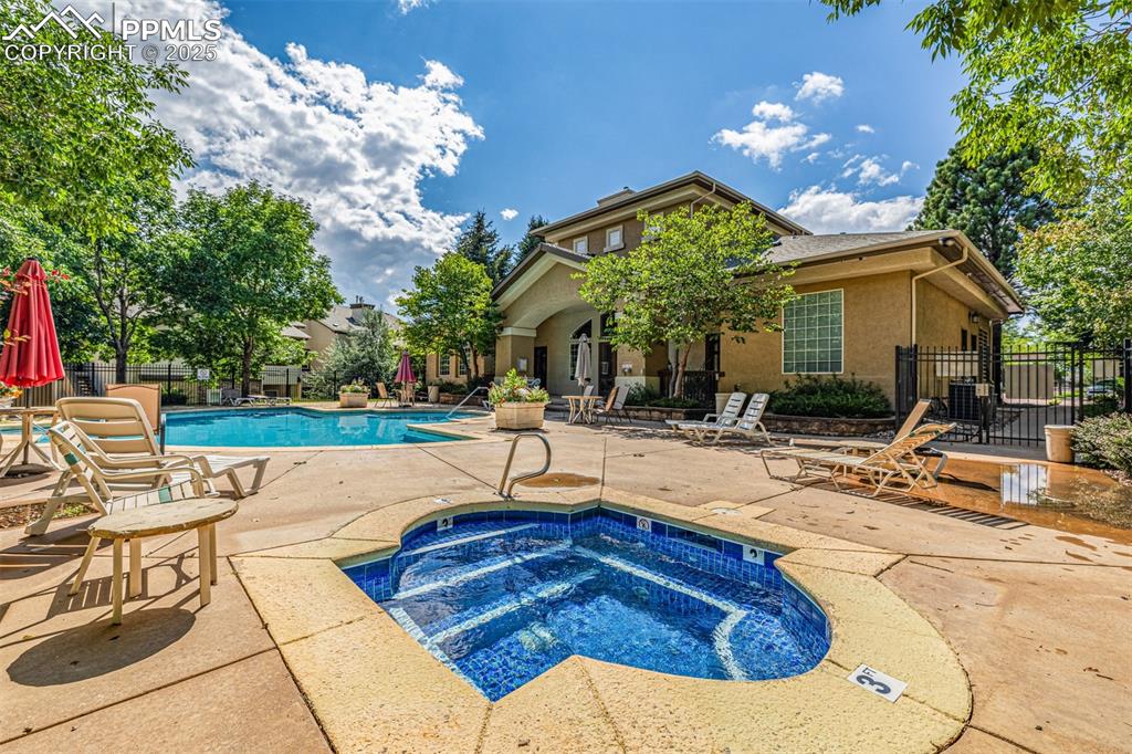 Community pool featuring a patio area and a community hot tub