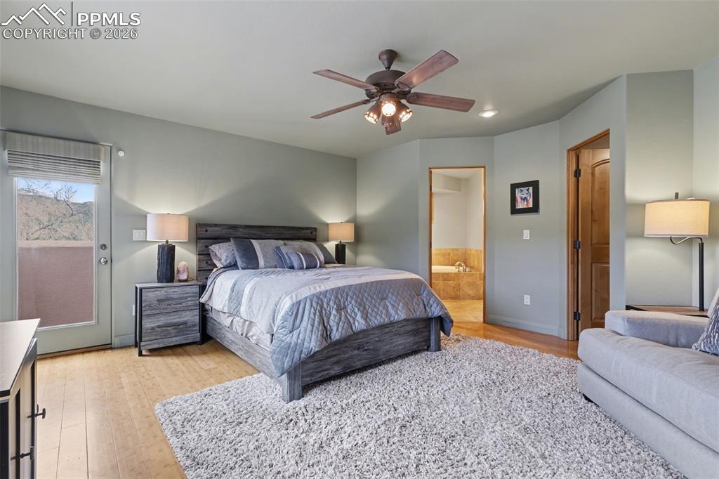 Primary suite, Walk in closet featuring light wood finished floors