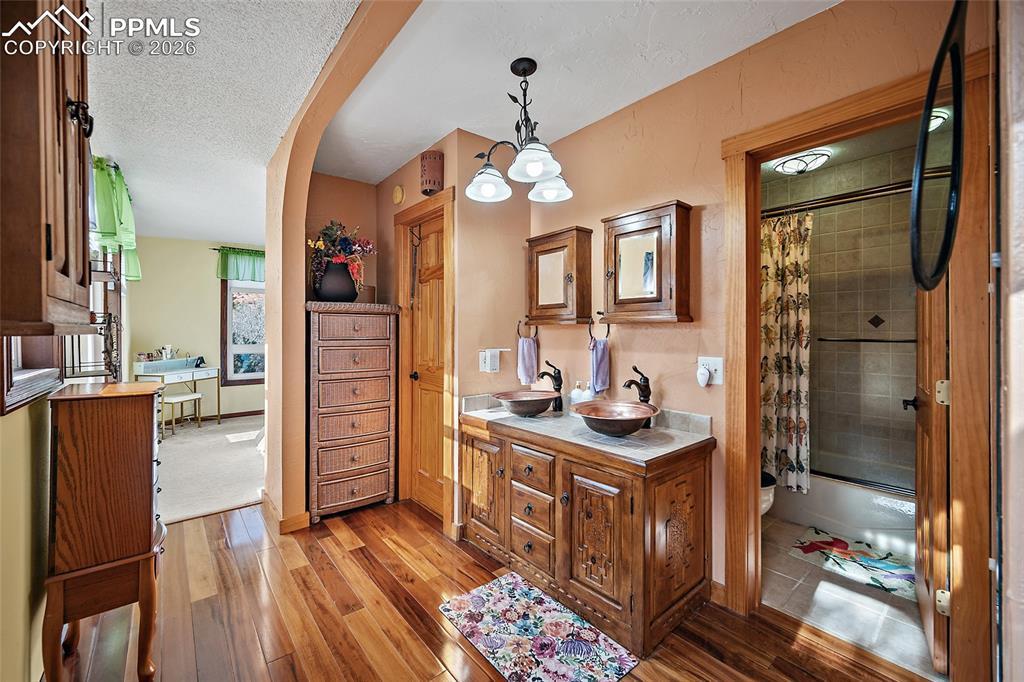 Master Bathroom leading to master bedroom in backrground.